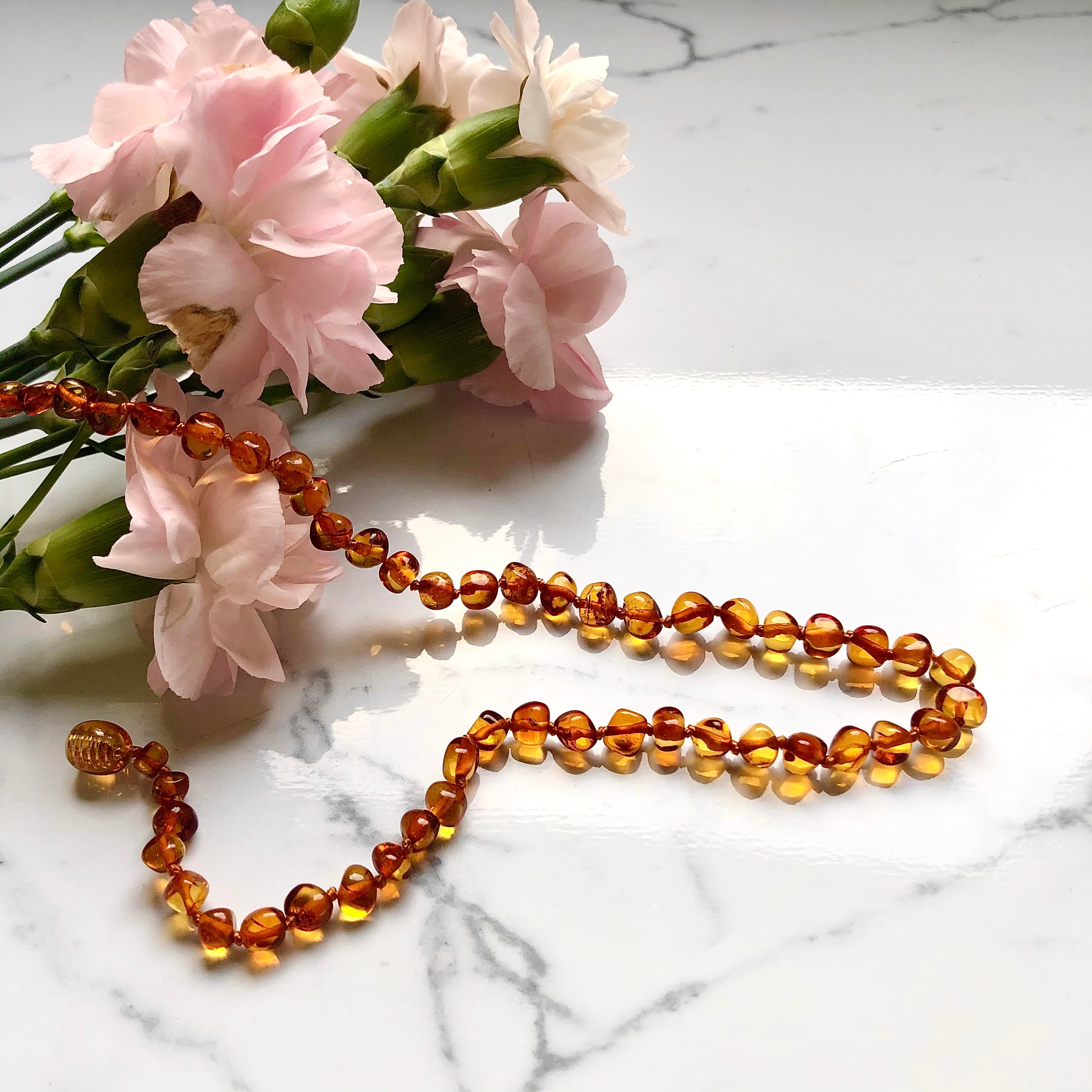 Pink amber online teething necklace